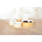 Appetizer set of 5 bowls on a round wooden tray